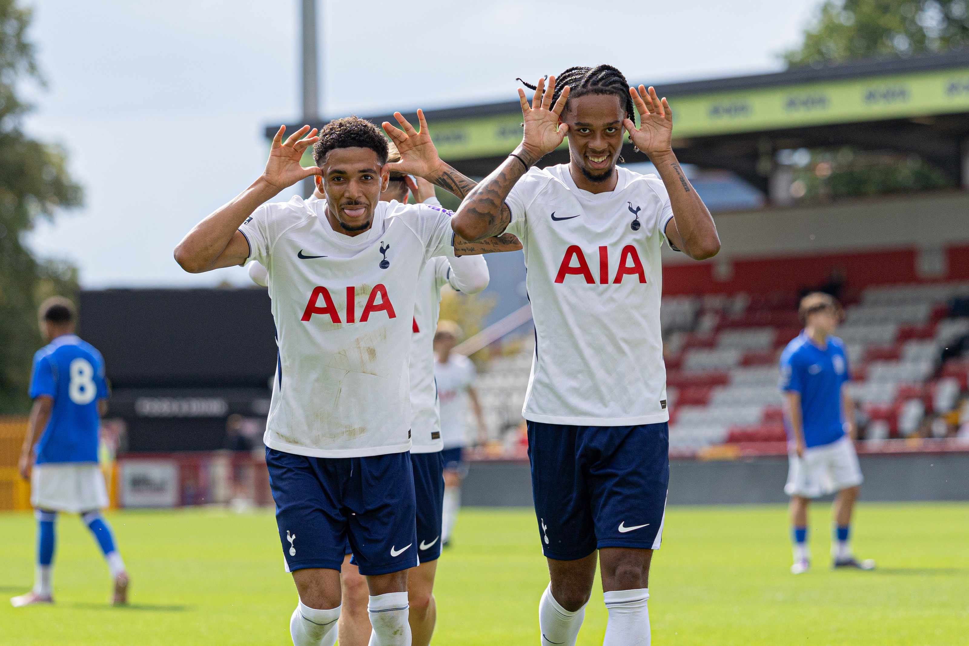 Tottenham players celebrating a goal in front of the stand