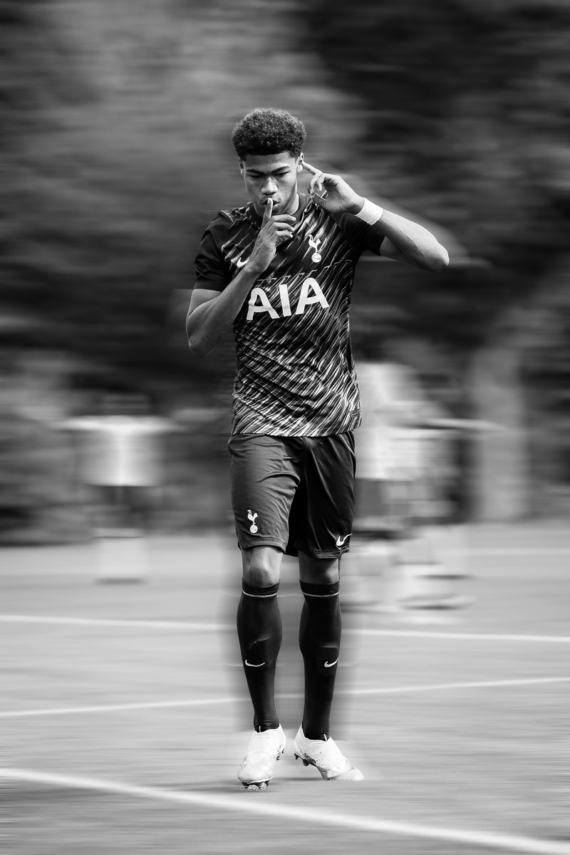Tottenham player with a finger to his lips, black and white, motion blur edit
