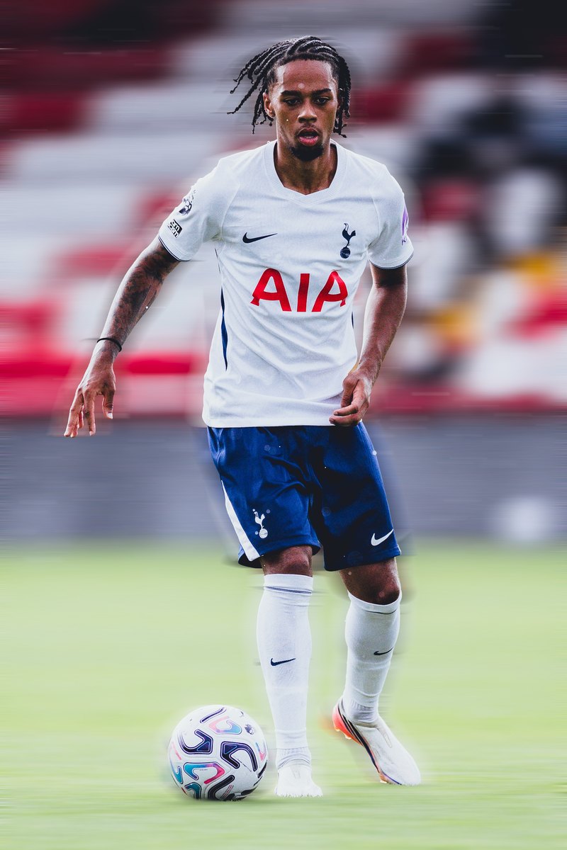 Tottenham player on the ball in front of red stands, motion blur edit