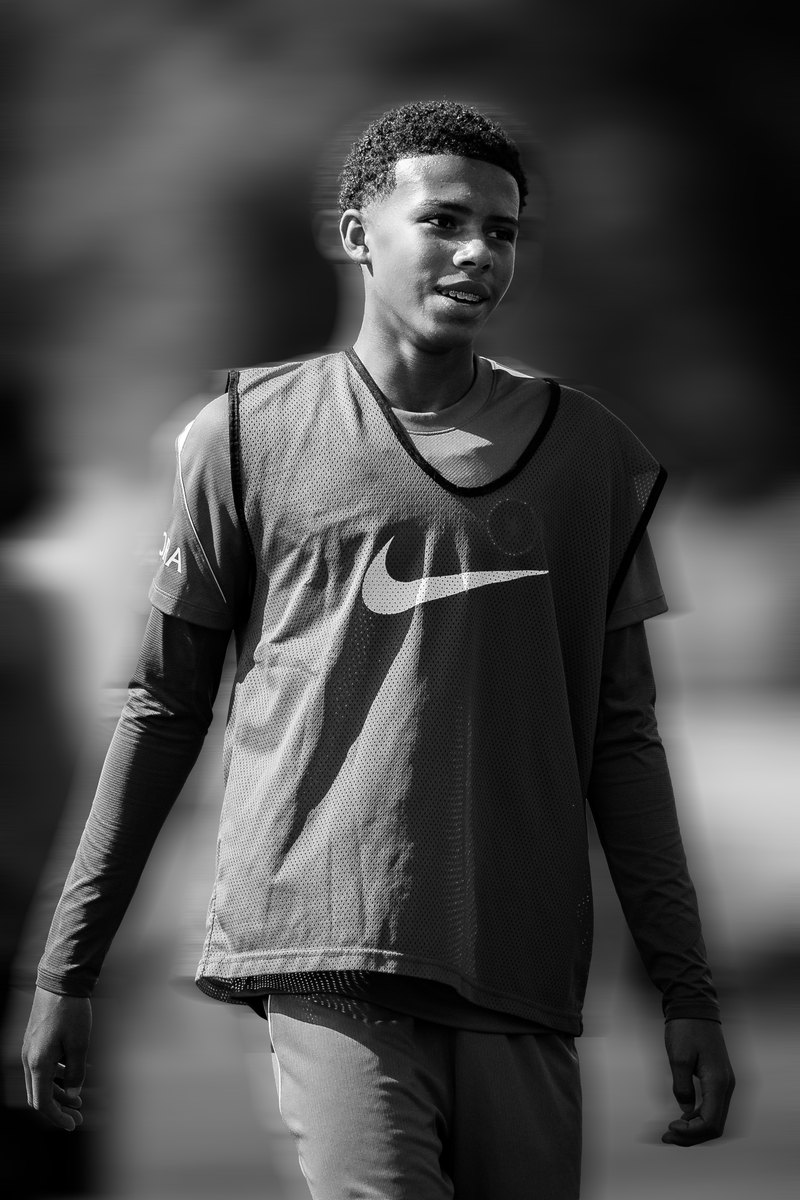 Player in a training bib, black and white, motion blur edit