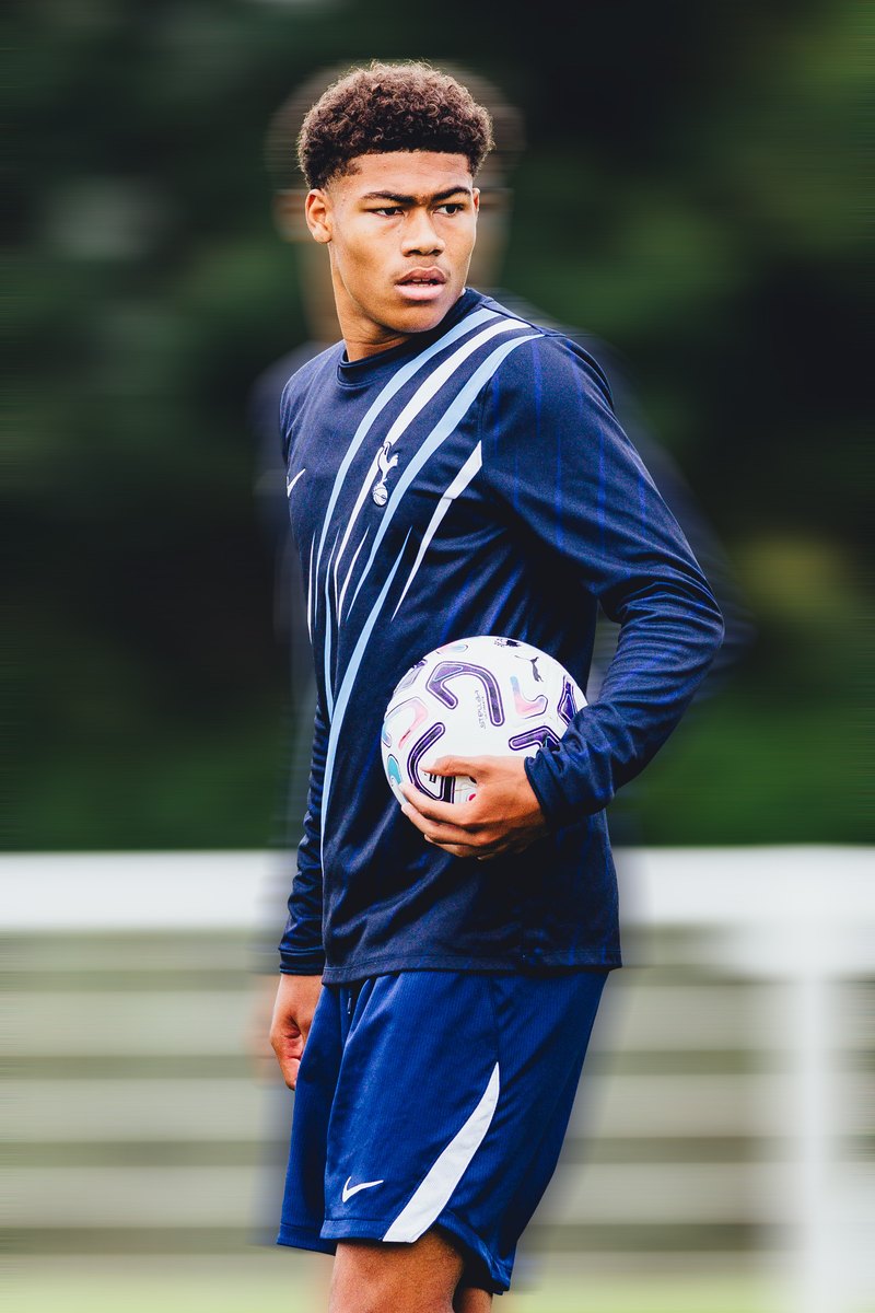 Tottenham player in a training top holding a ball, motion blur edit